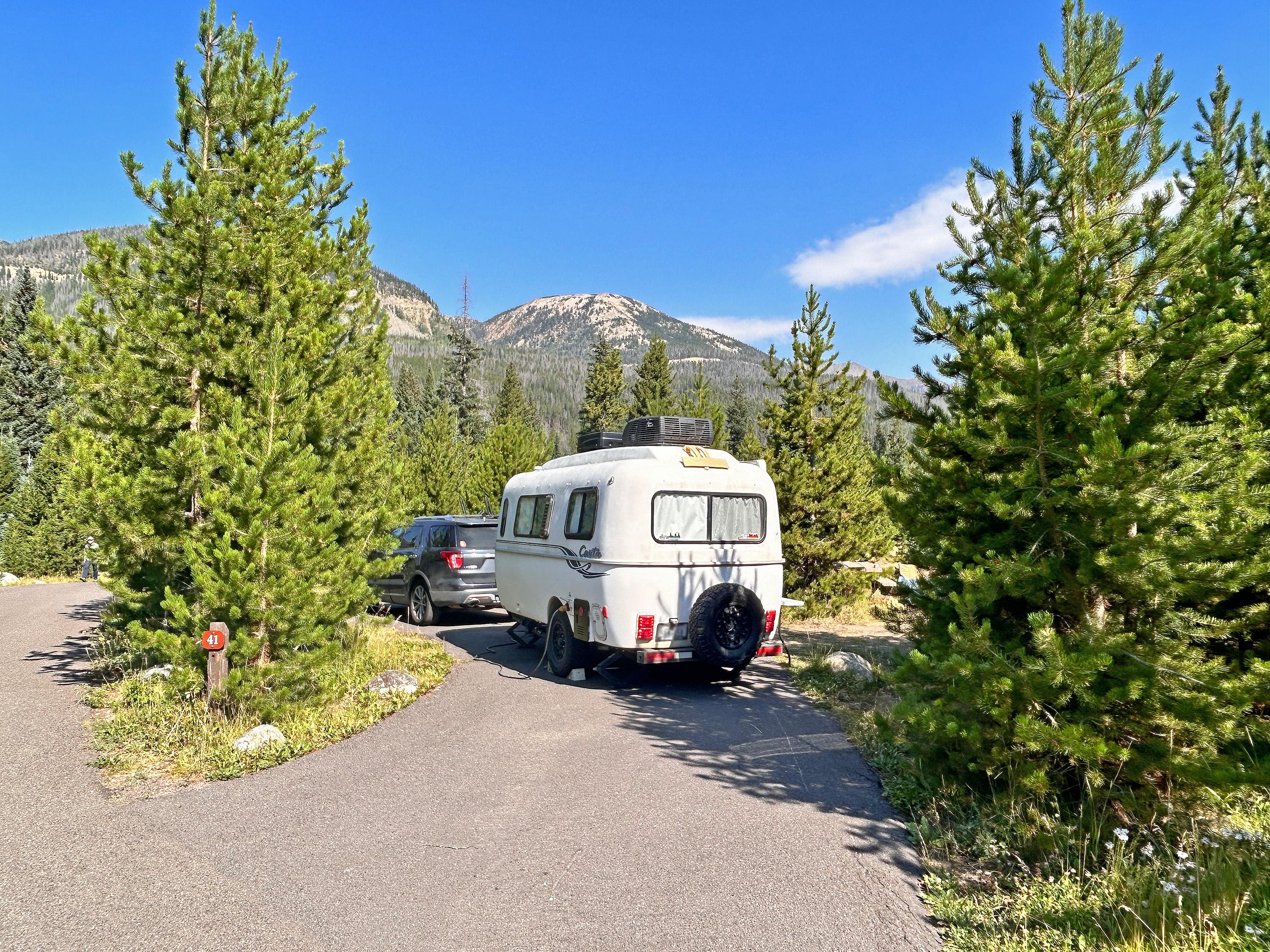 A trailer is set up in a campsite