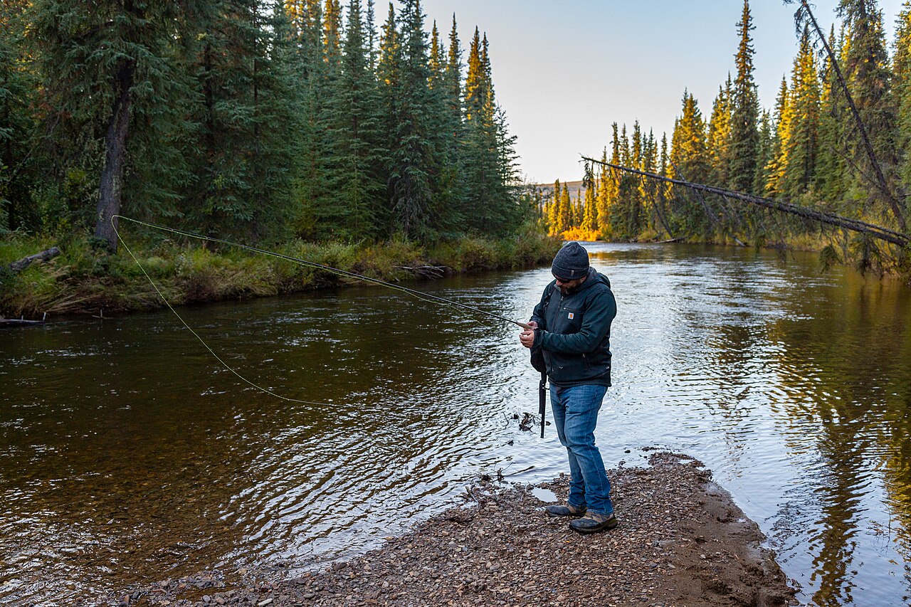 An angler adjusts his gear on Nome Creek at the Ophir Creek Campground, White Mountains National Recreation Area, Alaska. BLM photo by Craig McCaa.