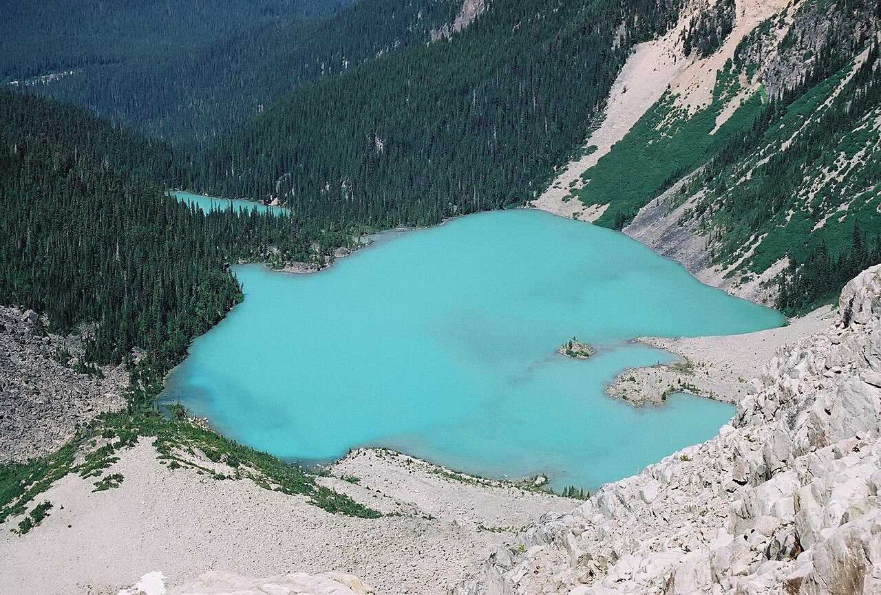 Two of the three Joffre Lakes show their milky blue colours nestled and protected in the steep, rocky cirque. The colour is due to fine glacier-fed particulates in the water. The Matier glacier however has receeded up the wall above the lake and no longer